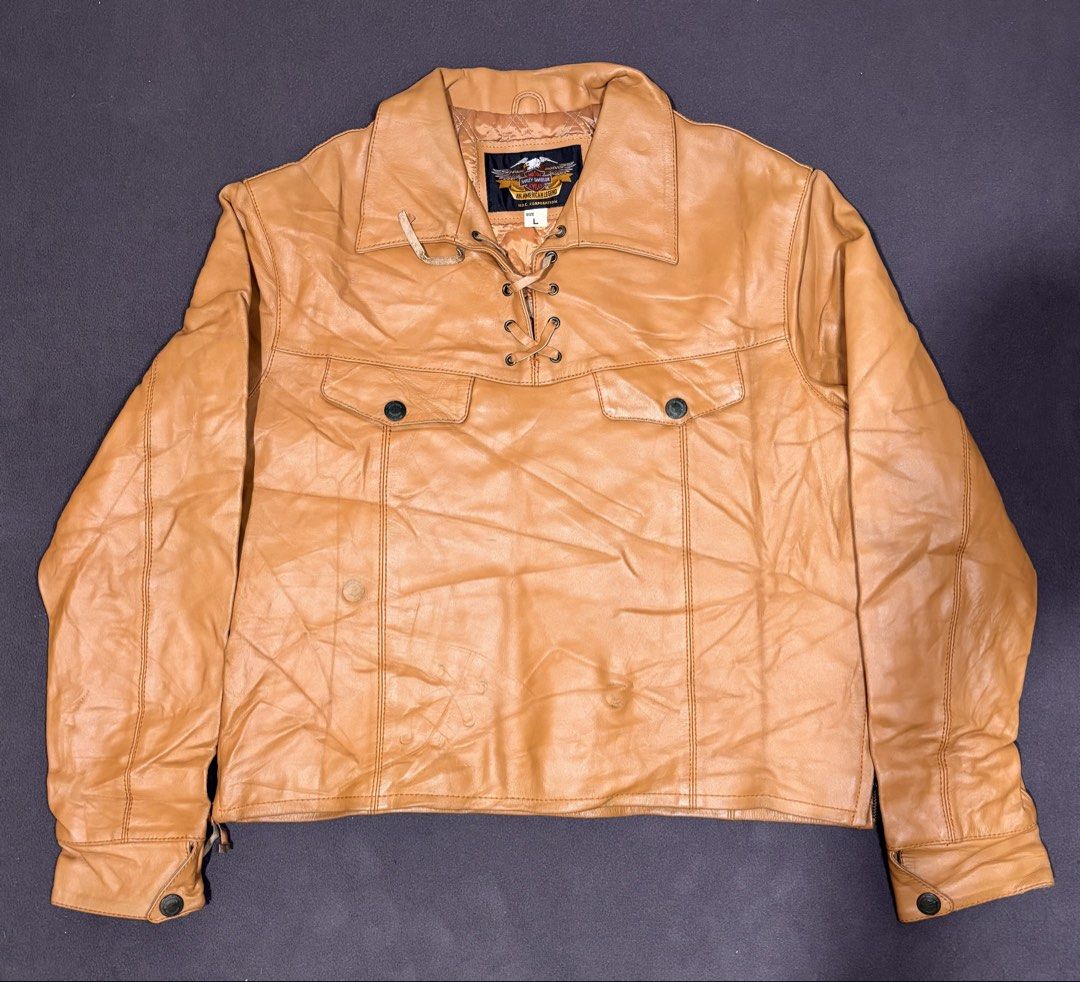 Harley Davidson Tan Leather Jacket Lace-Up Front Size L (Category: Coats, Jackets and Outerwear) located in Mabalacat. Submitted by _limitlessfashion (Listing ID 1468309827, Image 1). Description: - Brand: Vintage Harley-Davidson - Size: Large - Length 23 - Width 23 - No major issue, sign of use only - Color: Tan with natural vintage creasing and wear lines - Material: Genuine leather with cozy quilted lining - Closure/Neck: Front lace-up detail 
