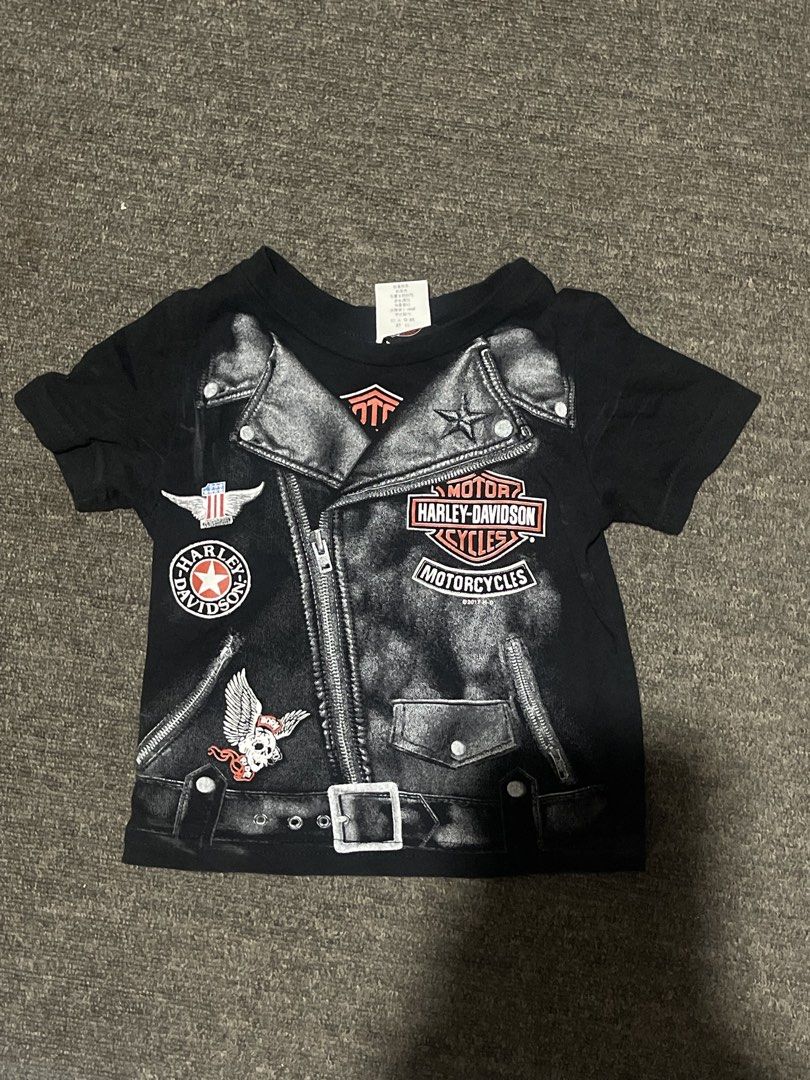 Y2K Harley-Davidson Baby Tee (Category: Shirts) located in Liliw. Submitted by j444mes (Listing ID 1468458122, Image 1). Description: - Brand: Official Harley-Davidson Merchandise - Year: 2016 - Size: 2T (Toddler) - Color: Black - Material: Comfortable cotton blend - Front Design: Biker jacket graphic with zippers, belt, and patches - Back Design: Taipei Taiwan dealership lettering.