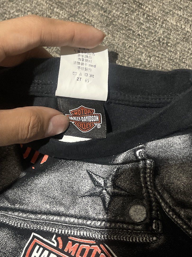 Y2K Harley-Davidson Baby Tee (Category: Shirts) located in Liliw. Submitted by j444mes (Listing ID 1468458122, Image 2). Description: - Brand: Official Harley-Davidson Merchandise - Year: 2016 - Size: 2T (Toddler) - Color: Black - Material: Comfortable cotton blend - Front Design: Biker jacket graphic with zippers, belt, and patches - Back Design: Taipei Taiwan dealership lettering.