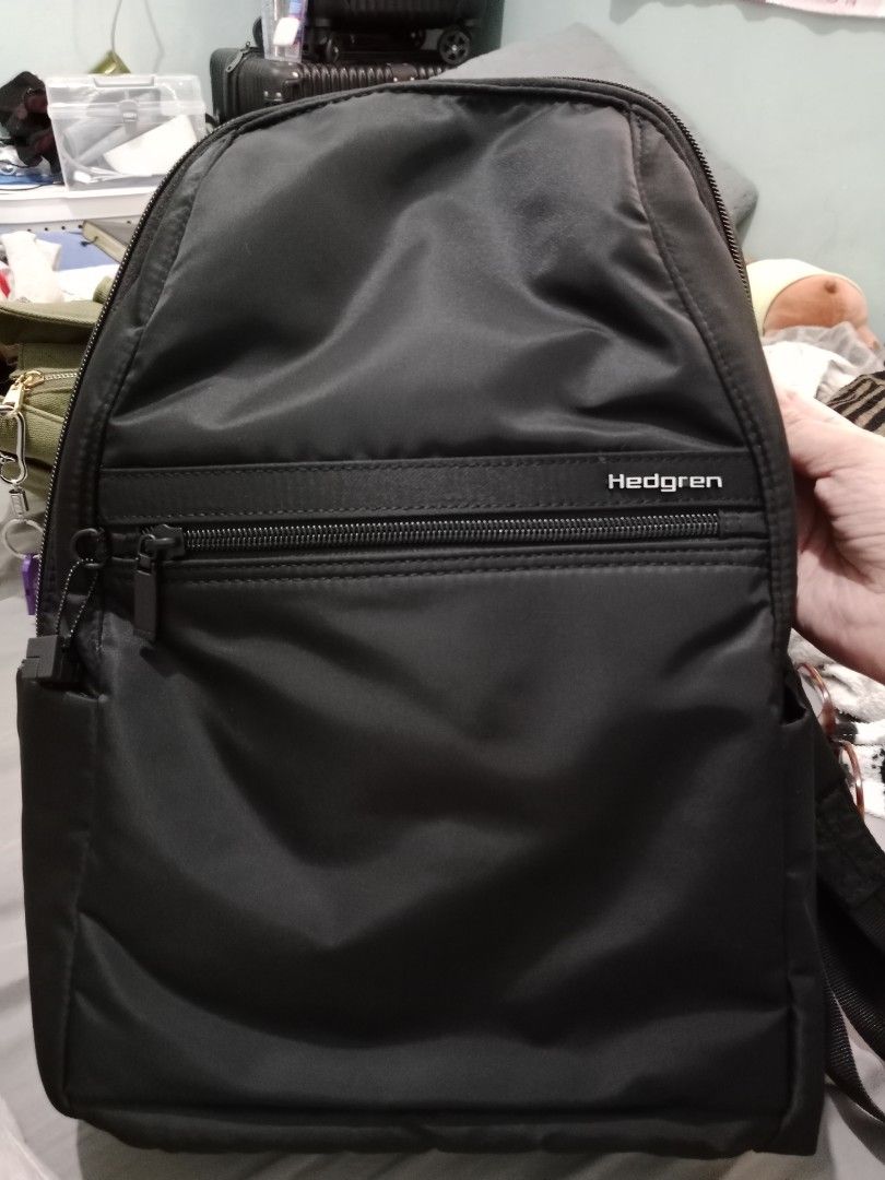 Hedgren Black Backpack with RFID Protected Pocket (Category: Backpacks) located in Cabuyao City. Submitted by jcbc0120 (Listing ID 1468324917, Image 1). Description: - Brand: Hedgren - Color: Sleek black nylon material - Exterior: Front zippered pocket across the middle, sturdy top grab handle - Interior: Padded slip sleeve and RFID-protected zippered pocket with red product tag - Comfort: Padded shoulder straps for all-day wear - Condition: Exce