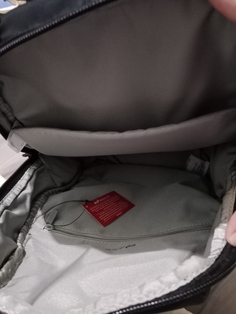 Hedgren Black Backpack with RFID Protected Pocket (Category: Backpacks) located in Cabuyao City. Submitted by jcbc0120 (Listing ID 1468324917, Image 2). Description: - Brand: Hedgren - Color: Sleek black nylon material - Exterior: Front zippered pocket across the middle, sturdy top grab handle - Interior: Padded slip sleeve and RFID-protected zippered pocket with red product tag - Comfort: Padded shoulder straps for all-day wear - Condition: Exce