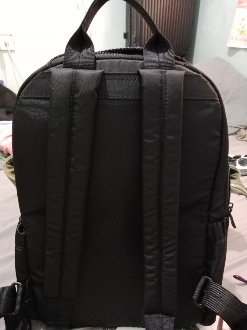 Hedgren Black Backpack with RFID Protected Pocket (Category: Backpacks) located in Cabuyao City. Submitted by jcbc0120 (Listing ID 1468324917, Image 3). Description: - Brand: Hedgren - Color: Sleek black nylon material - Exterior: Front zippered pocket across the middle, sturdy top grab handle - Interior: Padded slip sleeve and RFID-protected zippered pocket with red product tag - Comfort: Padded shoulder straps for all-day wear - Condition: Exce