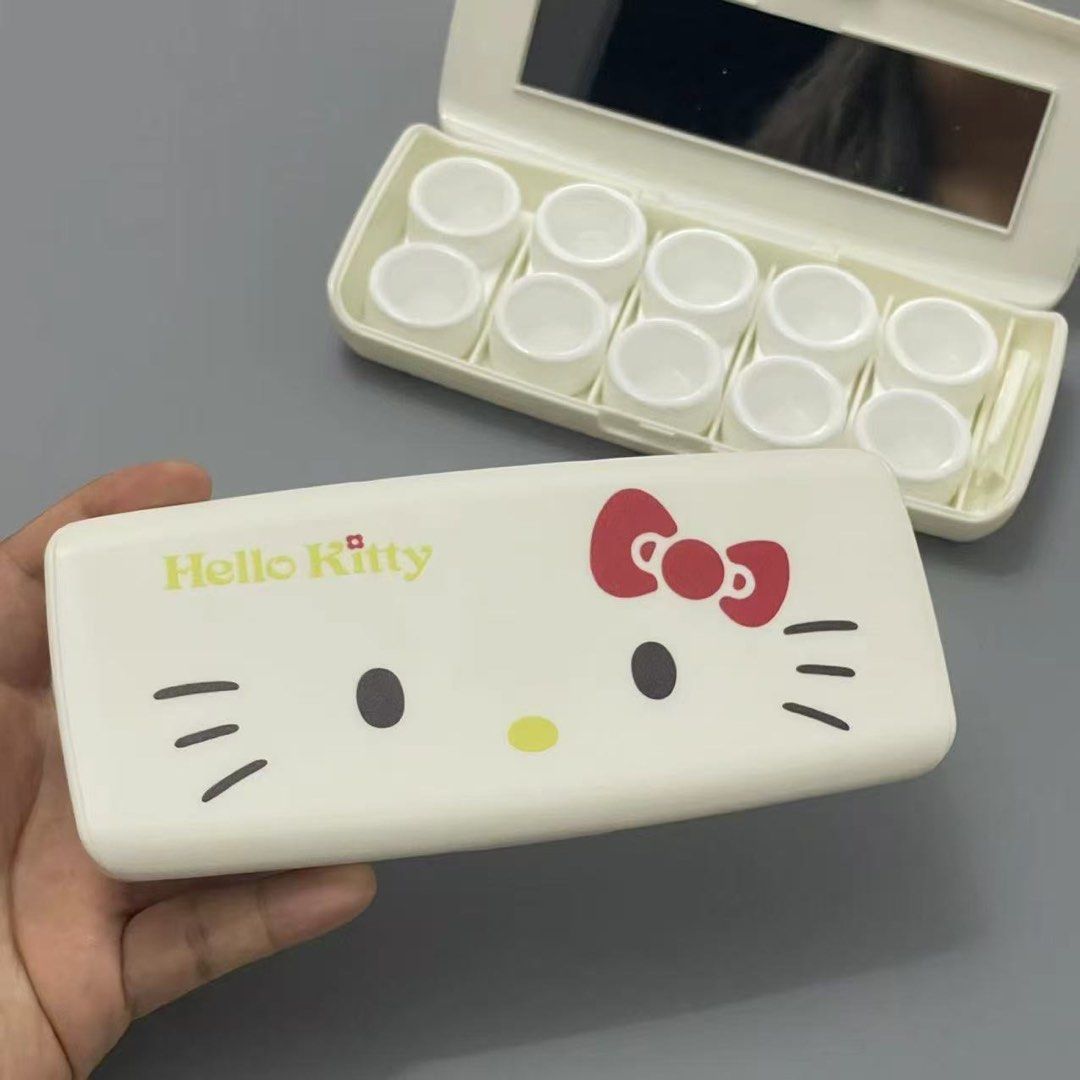 Hello Kitty Contact Lens Case with Mirror and Tool Set (Category: Purses & Pouches) located in Guiguinto. Submitted by sheena4 (Listing ID 1468331960, Image 1). Description: - Adorable white Kitty design with iconic red bow and yellow lettering - All-in-one travel set featuring a built-in mirror, small tweezers, and multiple empty screw-top containers - Compact rectangular shape that easily fits into any handbag or makeup pouch - Clean condition 