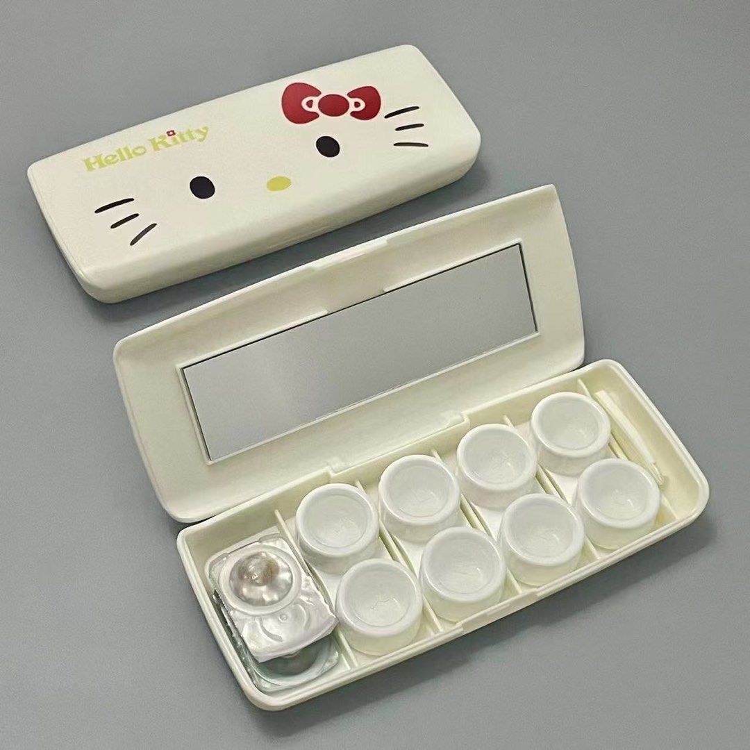 Hello Kitty Contact Lens Case with Mirror and Tool Set (Category: Purses & Pouches) located in Guiguinto. Submitted by sheena4 (Listing ID 1468331960, Image 2). Description: - Adorable white Kitty design with iconic red bow and yellow lettering - All-in-one travel set featuring a built-in mirror, small tweezers, and multiple empty screw-top containers - Compact rectangular shape that easily fits into any handbag or makeup pouch - Clean condition 