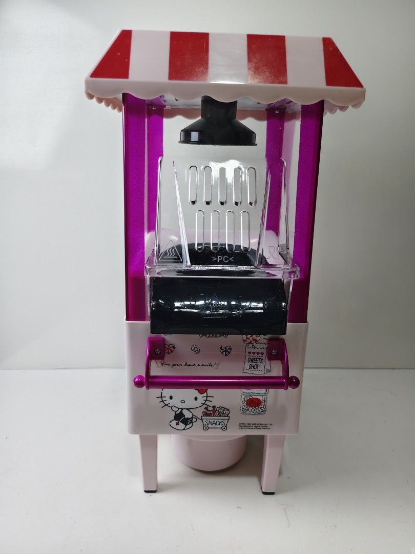 Hello Kitty Popcorn Maker Cart (Category: Food Organization & Storage) located in Las Pinas. Submitted by mommy_14 (Listing ID 1468378205, Image 3). Description: - Adorable Kitty vintage cart design with a red and white striped canopy - Fun and fast kitchen appliance for making fresh popcorn - Comes complete with the original packaging box - Perfect gift for Sanrio fans and kitchen collectors - Condition: Excellent, ready for display or use.