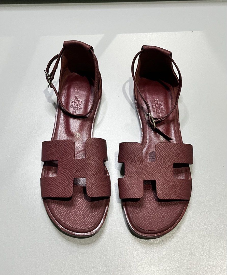 Hermès Santorini Flat Sandals (Category: Flats & Sandals) located in Pagadian. Submitted by lifetalirongan (Listing ID 1468294954, Image 1). Description: Hermès Santorini Flat Sandals in Rouge H (deep burgundy/red) Epsom calfskin leather, featuring the iconic “H” cut-out and an adjustable ankle strap..