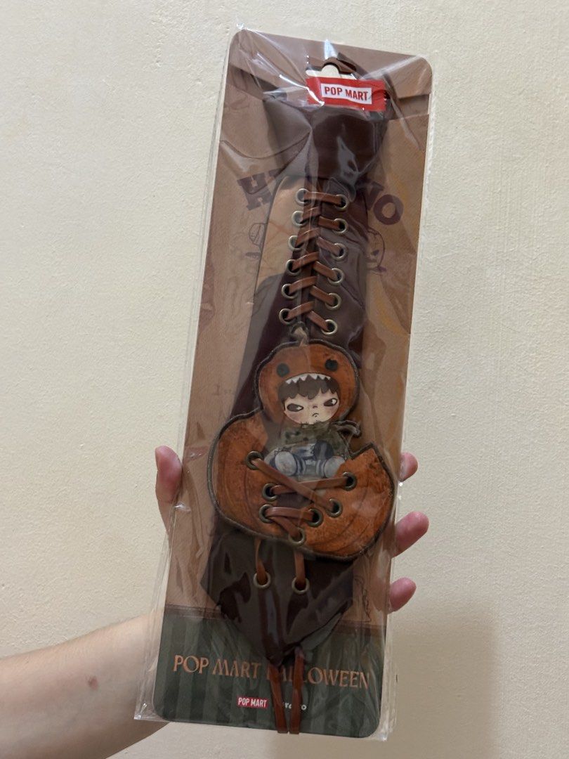 HIRONO Halloween Series Tie (Category: Ties) located in Las Pinas. Submitted by luvvjeon (Listing ID 1468398563, Image 1). Description: - Authentic POP MART Halloween Collection - Design: Hirono in a pumpkin costume (Brown colorway) - Features unique leatherette lace-up details - Condition: Brand new, sealed in original packaging - Perfect for designer toy collectors and fans.