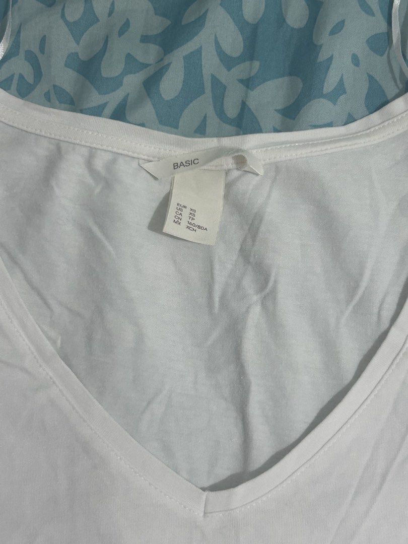 H&M Basic White V-Neck T-Shirt (Category: Shirts) located in Palo. Submitted by kaleidoscope_676 (Listing ID 1468295650, Image 2). Description: - Brand: H&M Basic - Style: White V-neck t-shirt with short sleeves and slim fit silhouette - Size: XS (EUR/US XS) - Material: Soft and comfortable cotton blend - Condition: Excellent, wardrobe staple - Pairing: Easily matches with jeans or skirts.