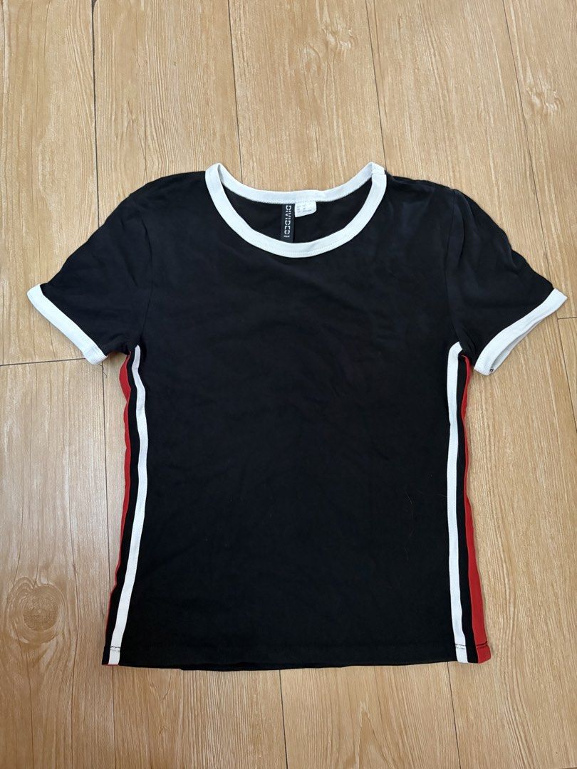 H&M Divided Black Tee with White and Red Side Stripes (Category: Shirts) located in Marikina City. Submitted by phelinky_finds (Listing ID 1468342280, Image 1). Description: 🛍️DESCRIPTION: - Brand: H&M Divided - Color/Style: Black with white ringer collar, cuffs, and contrasting white/red side stripes - Size: XS (slim fit) - Material: Comfortable cotton stretch fabric - Styling: Perfect casual top to pair with high-waisted jeans or shorts ✅ Cond