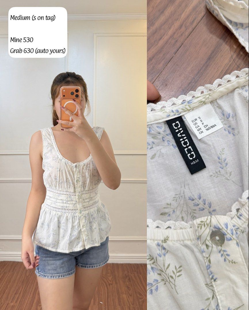 H&M Divided Floral Peplum Blouse (Category: Blouses) located in Manila. Submitted by angelll0123 (Listing ID 1468448355, Image 1). Description: - Brand: H&M Divided - Design: White with blue floral pattern, sleeveless, scoop neck - Details: Front button placket, delicate lace trim, ruched waistline - Size: Tagged S, fits like a Medium - Condition: Great everyday piece, easy to style with denim shorts or jeans.