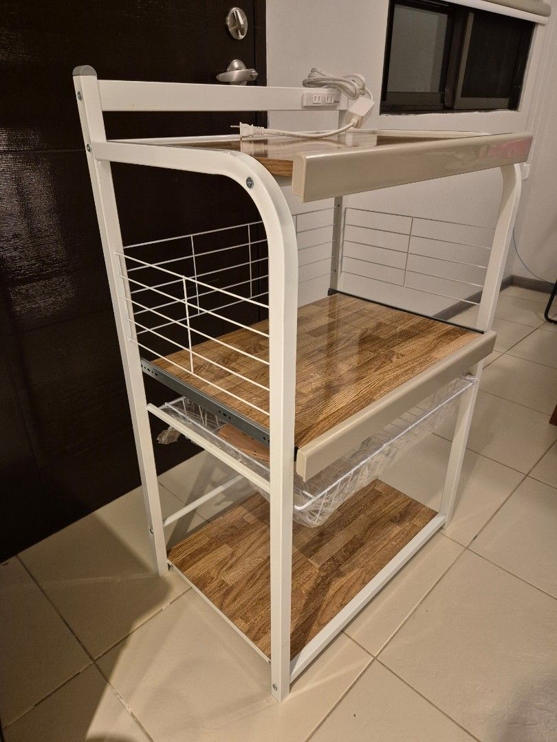 Home Accents 3-Layer Microwave Stand White / Kitchen table (Category: Shelves, Cabinets & Racks) located in Taguig. Submitted by martinarmandooo (Listing ID 1468338639, Image 3). Description: ✅️ Brandnew Never been used ✅️ RFS: bough the wrong size ✅️✅️ Selling below market price. - Brand: Home Accents multi-tier kitchen storage rack - Dimensions: 64 cm (W) x 43 cm (D) x 108 cm (H) - Design: White metal frame with wooden textured shelves - Featur