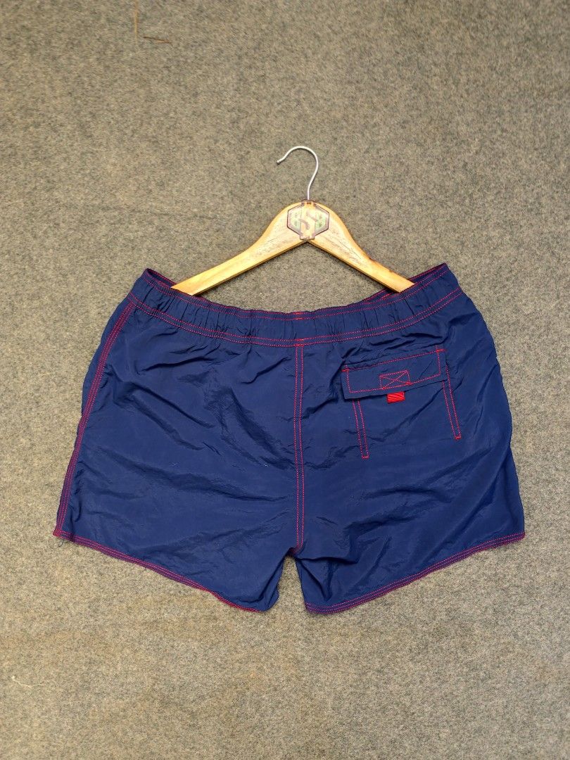 Hugo Boss Swim Shorts (Category: Swim Trunks & Board Shorts) located in Cordova. Submitted by bsb.streetluxvintage.clothing (Listing ID 1468424552, Image 3). Description: - Brand: Hugo Boss - Color: Blue with striking red contrast stitching and matching red drawstring - Features: Back pocket with flap closure and red tab, embroidered Hugo Boss logo near the hem - Material: Lightweight, quick-dry fabric ideal for swimming and beachwear.