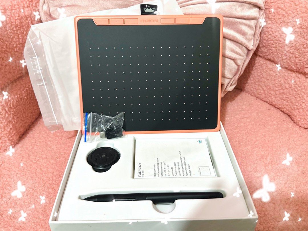 Huion Inspiroy RTS-300 Creative Pen Tablet (Category: Laptops & Notebooks) located in Adams. Submitted by precurekaei (Listing ID 1468403878, Image 2). Description: - Item: Huion Inspiroy RTS-300 Creative Pen Tablet - Color: Coral Pink and Black - Condition: Complete set in original packaging - Inclusions: Tablet, stylus pen, pen holder, adapters, and quick start guide - Best for: Digital art, sketching, and online teaching .