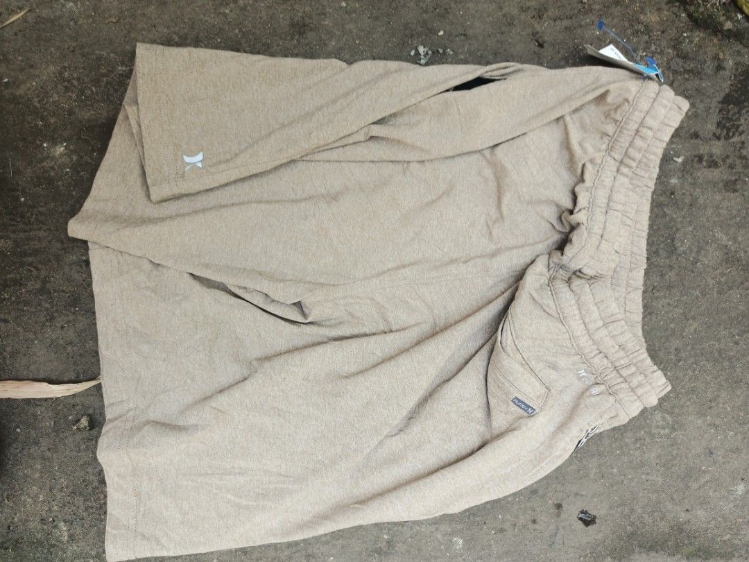 Hurley beige drawstring shorts (Category: Shorts) located in Manila. Submitted by vastdolphin.8d68cc (Listing ID 1468324485, Image 1). Description: - Brand: Hurley - Color: Beige - Condition: Brand new with original tags attached - Material: Lightweight and comfortable fabric - Features: Elastic waistband with drawstring, small logo near the hem, and back pocket with Hurley tag - Best for: Casual wear, lounging, or beach trips.