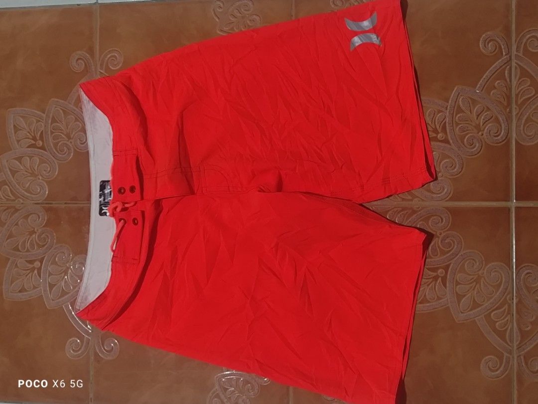 Hurley Board Shorts Orange Swim Trunks (Category: Swim Trunks & Board Shorts) located in Manila. Submitted by carlthrift3 (Listing ID 1468437221, Image 1). Description: - Bright orange Hurley board shorts - Ideal for swimming, surfing, and beach days - Lightweight fabric that dries fast - White inner waistband with adjustable drawstring - Features iconic Hurley logo on the right leg - Standard fit for all-day comfort.