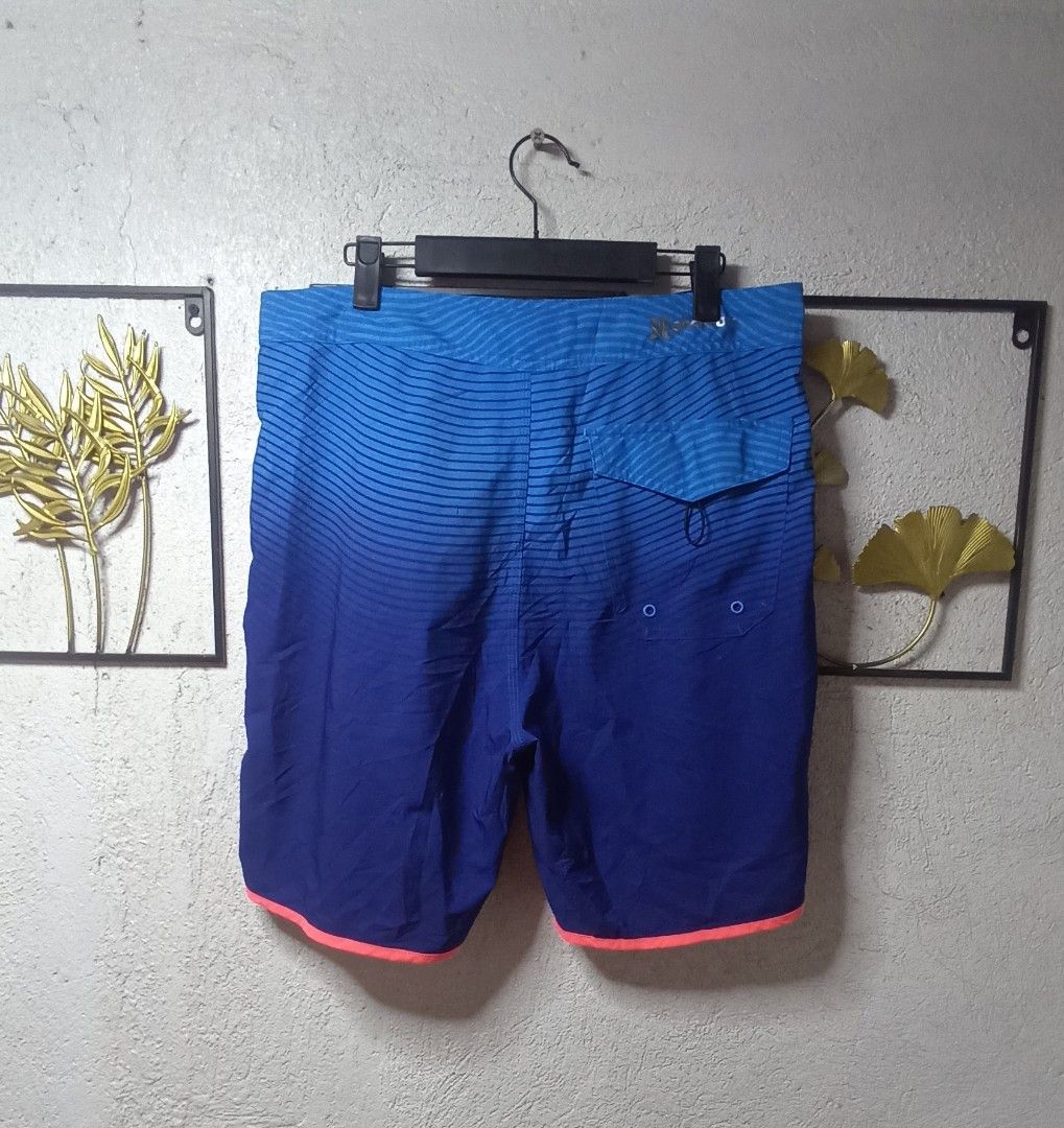 Hurley Board Shorts USA Olympic Team Phantom (Category: Swim Trunks & Board Shorts) located in Kawit. Submitted by deidzdzn (Listing ID 1468327803, Image 3). Description: - Authentic Hurley Phantom USA Olympic Team collection - Striking blue ombre fade with neon pink piping and drawstrings - Large USA lettering on left leg, American flag patch and Olympic badge on right - Secure back pocket with zip closure - Tag size 33, fits waist 34-35 inches 