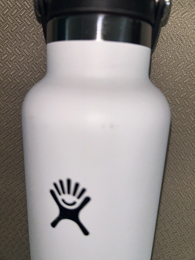 Hydro Flask White Water Bottle (Category: Water Bottles & Tumblers) located in Pasig City. Submitted by piayayaya511 (Listing ID 1468408243, Image 3). Description: - Authentic Hydro Flask water bottle in white - Includes a black cap with a flexible carry strap - Comes with a blue silicone boot to prevent dents and scratches - Keeps drinks cold for hours - Condition: Clean overall with minor scuffs near the neck area from normal use.