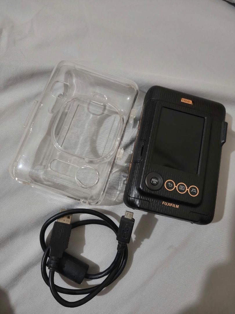 Instax Mini LiPlay FujiFilm (Category: Cameras) located in Quezon City. Submitted by creamymatchaaaaonlyyyy (Listing ID 1468399652, Image 2). Description: Good as new , nakatambak nalang honest issue gasgas lang ,di nakakaaffect sa pics * Take photos and print them instantly using Instax Mini film. * Print photos from your phone through Bluetooth. * Add sound to photos by recording audio and printing a QR code on the photo. * Choose your favorite
