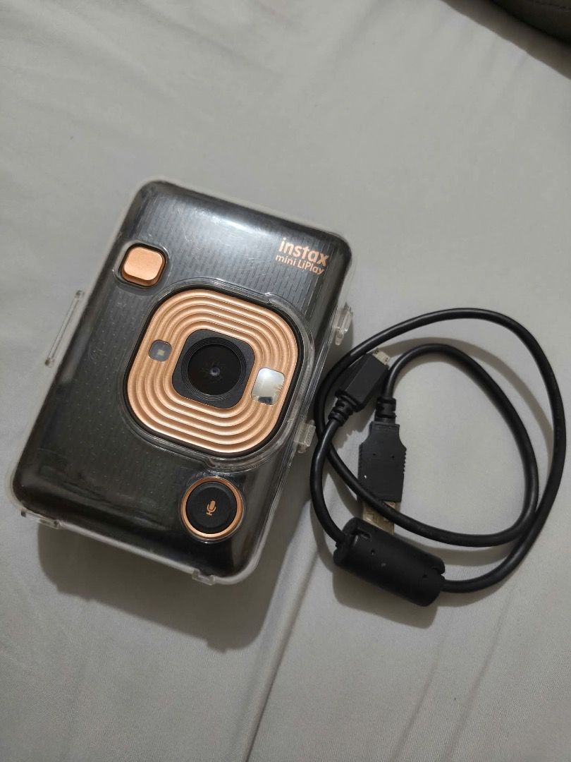 Instax Mini LiPlay FujiFilm (Category: Cameras) located in Quezon City. Submitted by creamymatchaaaaonlyyyy (Listing ID 1468399652, Image 1). Description: Good as new , nakatambak nalang honest issue gasgas lang ,di nakakaaffect sa pics * Take photos and print them instantly using Instax Mini film. * Print photos from your phone through Bluetooth. * Add sound to photos by recording audio and printing a QR code on the photo. * Choose your favorite