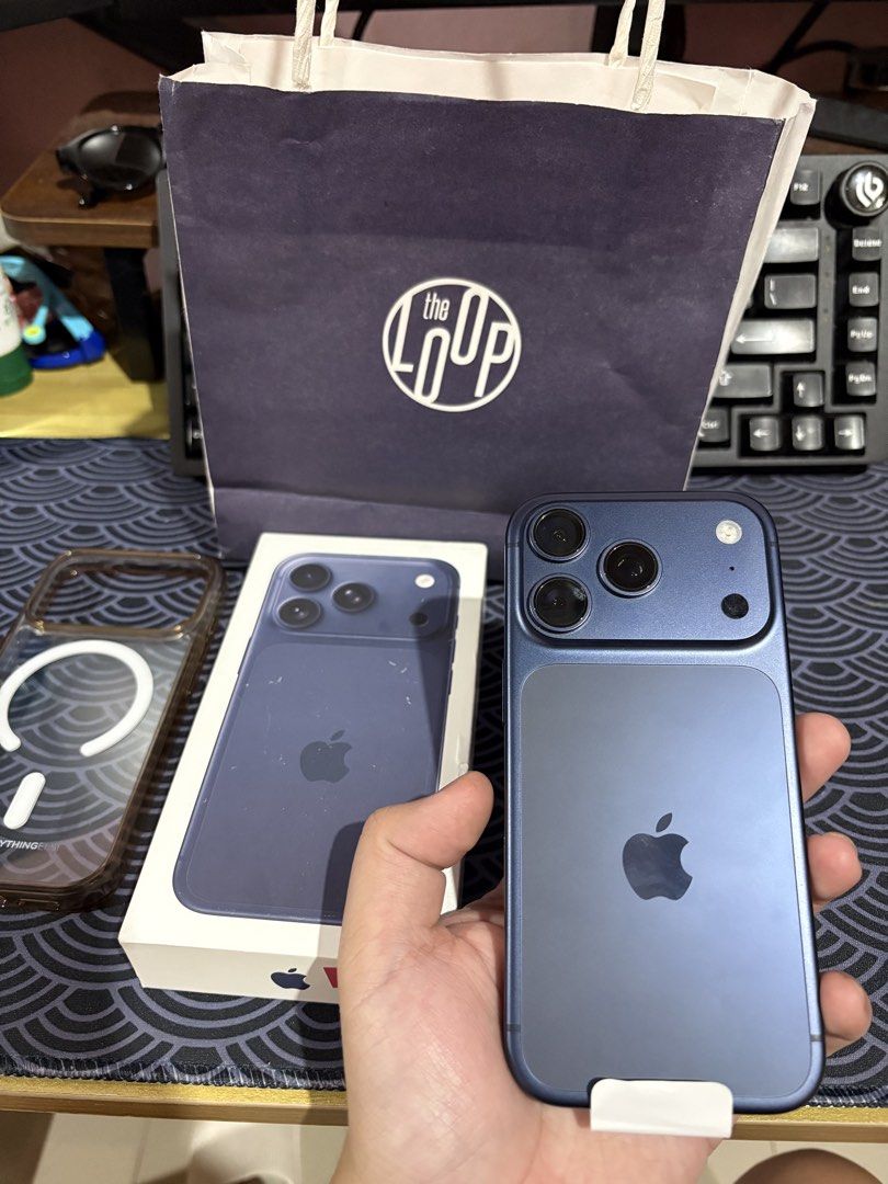 Iphone 17 Pro (Category: iPhone 17 Series) located in Pasig City. Submitted by polrz (Listing ID 1468476397, Image 1). Description: - Model: iPhone 17 Pro - Color: Deep blue - Battery Health: 89% (350 cycle counts) - Timeline: Manufactured August 2025, First used October 2025 - Condition: Works great, smooth performance - Inclusions: Original box, The Loop paper bag, and clear MagSafe case.