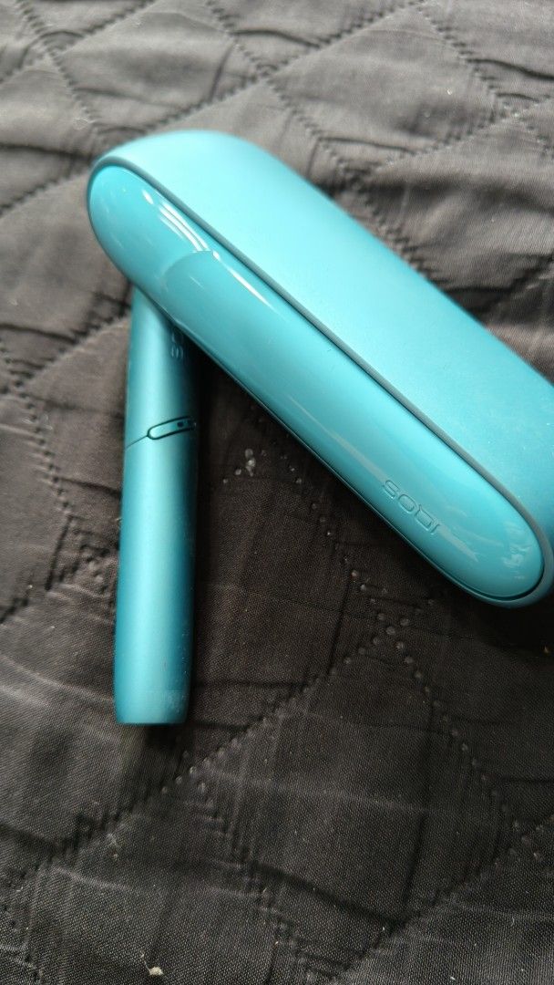 IQOS heated tobacco device teal (Category: Other Gadgets) located in Manila. Submitted by ryenne_leigh (Listing ID 1468321407, Image 2). Description: - Color: Teal - Includes: Holder and charger case - Condition: Fully functional, charges well, buttons click properly, regularly cleaned - Cosmetic: Minor signs of wear on the finish from normal handling - Feature: Compact size, perfect for daily carry.