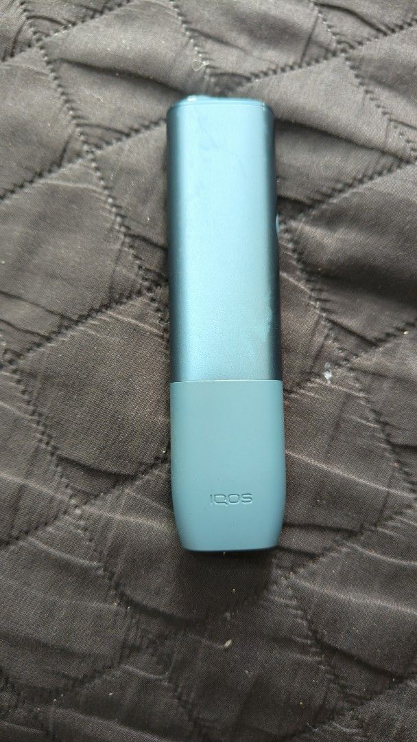 IQOS heated tobacco device teal (Category: Other Gadgets) located in Manila. Submitted by ryenne_leigh (Listing ID 1468321407, Image 3). Description: - Color: Teal - Includes: Holder and charger case - Condition: Fully functional, charges well, buttons click properly, regularly cleaned - Cosmetic: Minor signs of wear on the finish from normal handling - Feature: Compact size, perfect for daily carry.