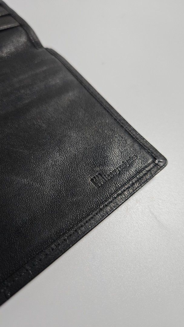 Issey miyake Black Leather Long Wallet (Category: Wallets & Card holders) located in Alfonso. Submitted by jbcamet (Listing ID 1468389243, Image 3). Description: - Brand: issey miyake - Material: Genuine lack leather - Design: Slim profile, fits easily in pockets or bags - Storage: Multiple card slots and spacious bill compartments - Condition: Surface scratches and wear marks from daily use - Durability: Sturdy stitching all around - Interior: C