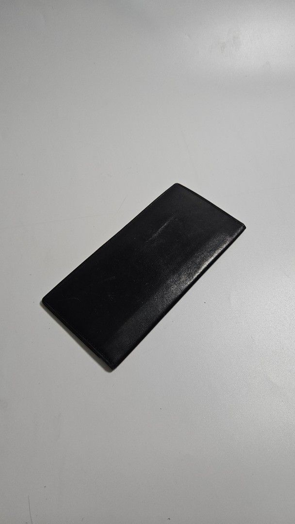 Issey miyake Black Leather Long Wallet (Category: Wallets & Card holders) located in Alfonso. Submitted by jbcamet (Listing ID 1468389243, Image 1). Description: - Brand: issey miyake - Material: Genuine lack leather - Design: Slim profile, fits easily in pockets or bags - Storage: Multiple card slots and spacious bill compartments - Condition: Surface scratches and wear marks from daily use - Durability: Sturdy stitching all around - Interior: C