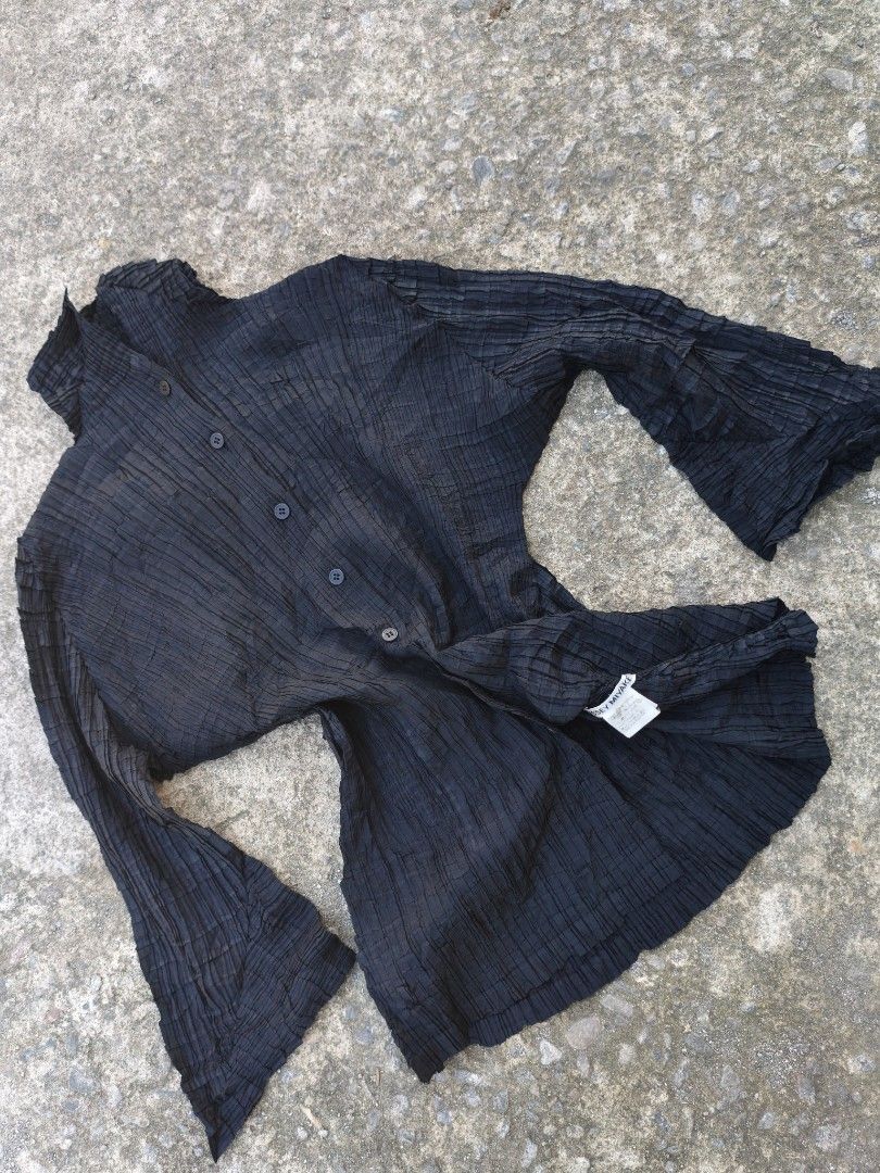 Issey Miyake Black Pleated Button-Up Blouse Size 2 (Category: Blouses) located in Bacolod City. Submitted by luciddreams07 (Listing ID 1468331005, Image 1). Description: - Brand: Issey Miyake - Color: Classic Black - Style: Pleated long-sleeve blouse with front buttons and high collar - Style Number: IM07-FJ306 - Size: Label shows Size 2 - Material: 100% Polyester - Origin: Made in the Philippines - Care: Hand wash only (instructions on inner tag