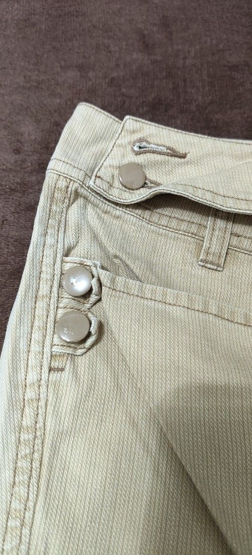 Izzue Beige Corduroy Pants Size 26 (Category: Jeans) located in Manila. Submitted by snz_shop (Listing ID 1468472666, Image 2). Description: - Brand: Izzue - Size: 26 - Color: Classic beige - Material: Textured corduroy fabric - Fit: Bootcut leg style - Closure: Zipper fly with dual button fastening - Details: Cute button accents near pockets and waistband, plus standard back pockets.