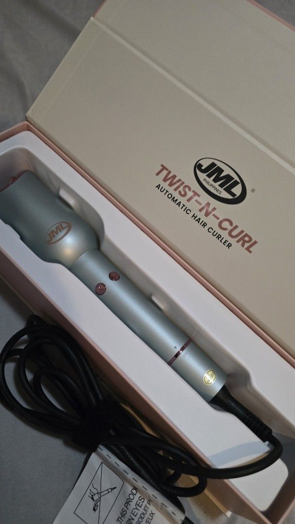 JML Twist-N-Curl Automatic Hair Styler (Category: Hair) located in Quezon City. Submitted by momof3_11 (Listing ID 1468393235, Image 1). Description: - Brand: JML Twist-N-Curl Automatic Hair Styler - Color: Sleek Silver and Rose Gold - Barrel: 23mm ceramic coating with anti-scald design - Temperature: Adjustable from 160°C to 220°C - Controls: Left and right curling buttons for easy styling - Cord: 360-degree swivel cord for tangle-free use - Inc
