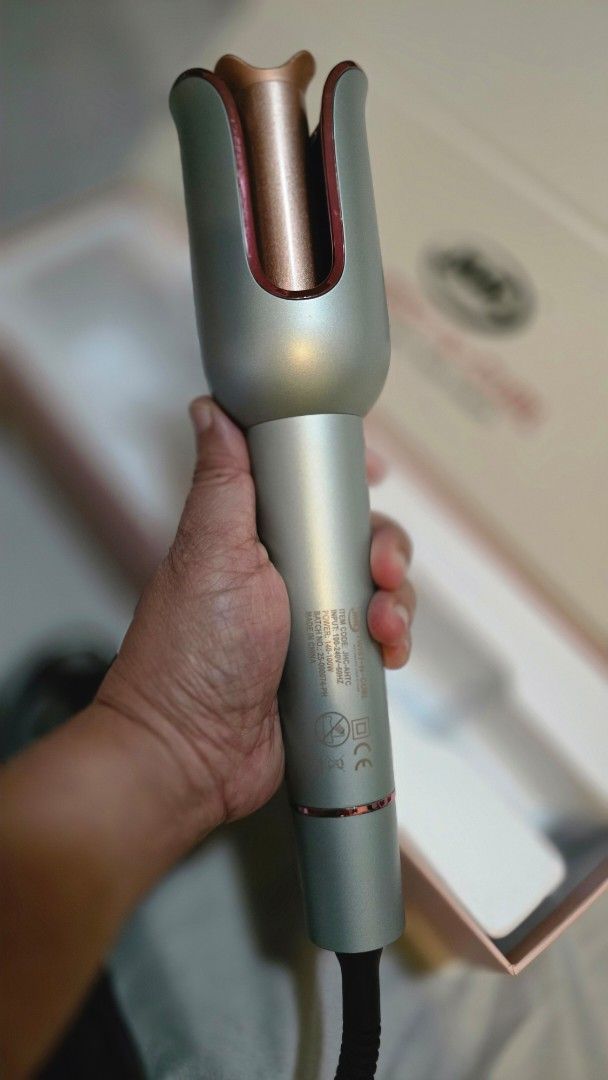 JML Twist-N-Curl Automatic Hair Styler (Category: Hair) located in Quezon City. Submitted by momof3_11 (Listing ID 1468393235, Image 2). Description: - Brand: JML Twist-N-Curl Automatic Hair Styler - Color: Sleek Silver and Rose Gold - Barrel: 23mm ceramic coating with anti-scald design - Temperature: Adjustable from 160°C to 220°C - Controls: Left and right curling buttons for easy styling - Cord: 360-degree swivel cord for tangle-free use - Inc