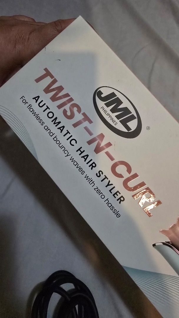 JML Twist-N-Curl Automatic Hair Styler (Category: Hair) located in Quezon City. Submitted by momof3_11 (Listing ID 1468393235, Image 3). Description: - Brand: JML Twist-N-Curl Automatic Hair Styler - Color: Sleek Silver and Rose Gold - Barrel: 23mm ceramic coating with anti-scald design - Temperature: Adjustable from 160°C to 220°C - Controls: Left and right curling buttons for easy styling - Cord: 360-degree swivel cord for tangle-free use - Inc