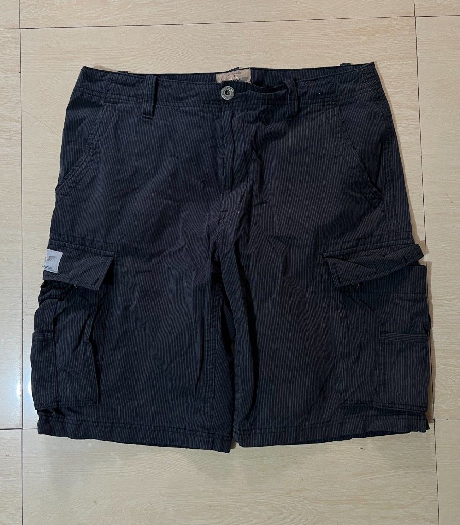 JNCO-85 Pinstripe Cargo Shorts Dark Grey (Category: Shorts) located in Manila. Submitted by kaloyyyyyy (Listing ID 1468346799, Image 2). Description: - Brand/Model: JNCO-85 dark grey pinstripe cargo shorts - Style: Classic Y2K skater cargo - Storage: Multiple utility pockets including side cargo and rear button flaps - Details: Distinctive JNCO-85 back waistband embroidery, branded button closure, and fabric patch label - Material: Sturdy cotton 