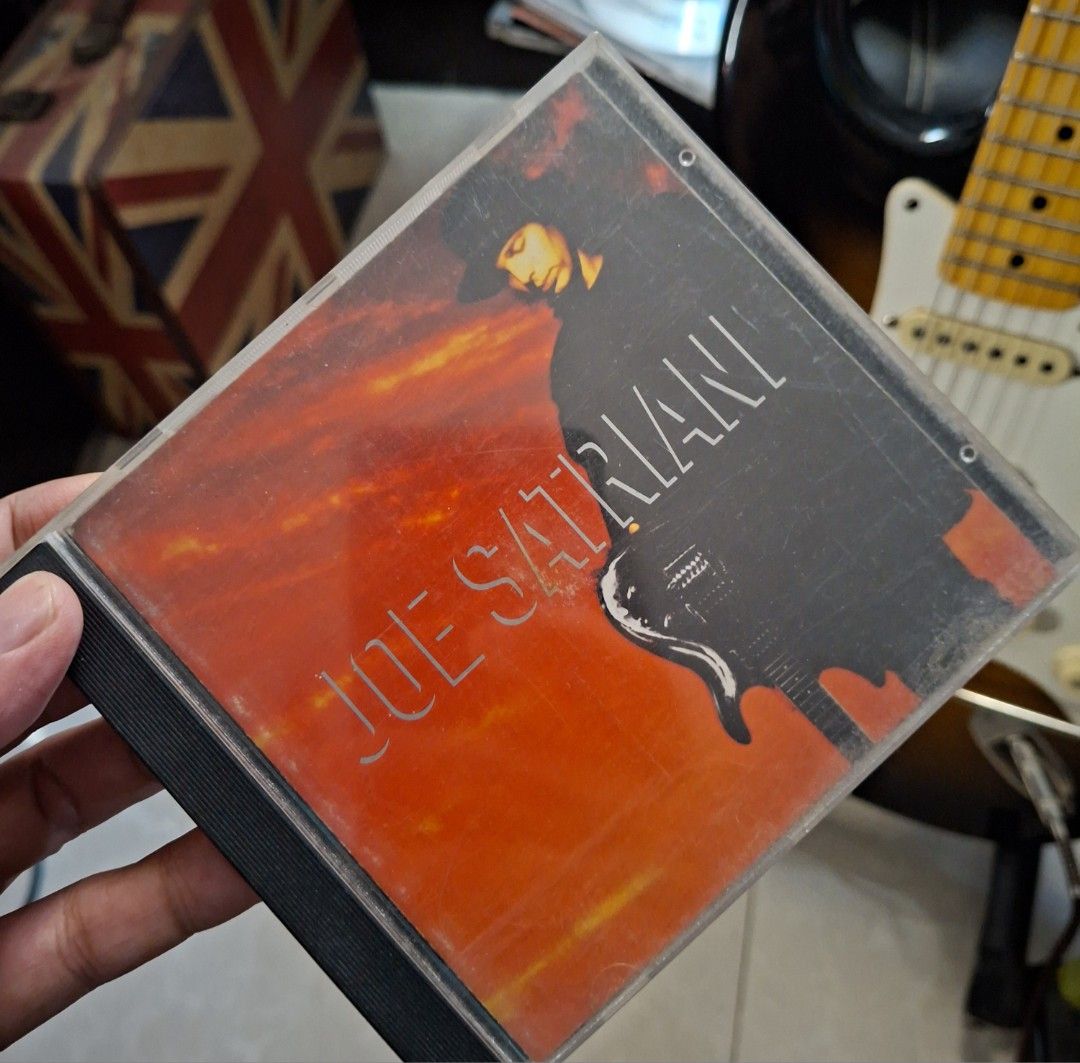 Joe Satriani Self Titled CD Album (Category: CDs & DVDs) located in Manila. Submitted by djonathannagtalon-55936 (Listing ID 1468347962, Image 1). Description: - Artist & Album: Joe Satriani (Self-Titled Instrumental Rock Album) - Format: Audio CD with standard jewel case and front insert artwork - Condition (Case): Plastic case shows normal surface scuffs from handling and storage - Condition (Disc): Plays fine with no issues - Genre: Classic gu