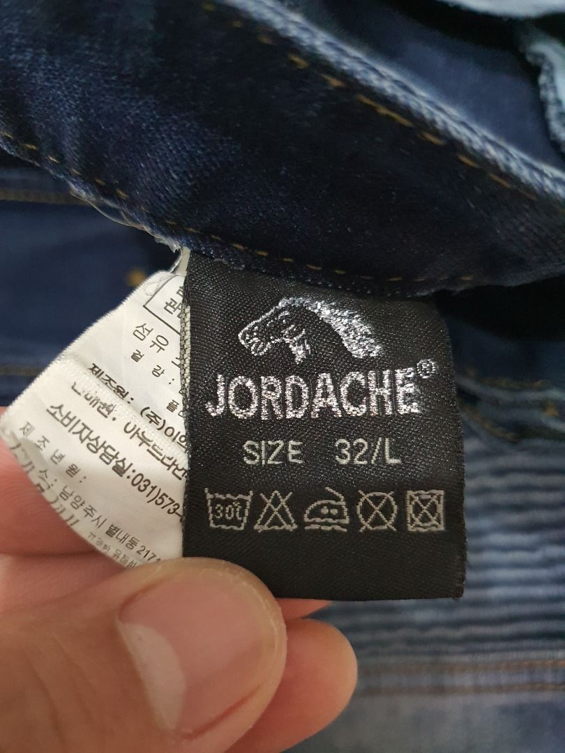 Jordache Biker Cargo Jeans Blue Men's Pants (Category: Jeans) located in Caloocan City. Submitted by cleverwind_1e53ab (Listing ID 1468304093, Image 3). Description: - Brand: Jordache - Color: Dark blue wash with subtle fading - Style: Biker streetwear cargo jeans - Fit: Straight leg cut - Features: Pleated knee panels, multiple front zipper pockets, side cargo pockets, and heavy stitching detail throughout - Closure: Standard button closure with
