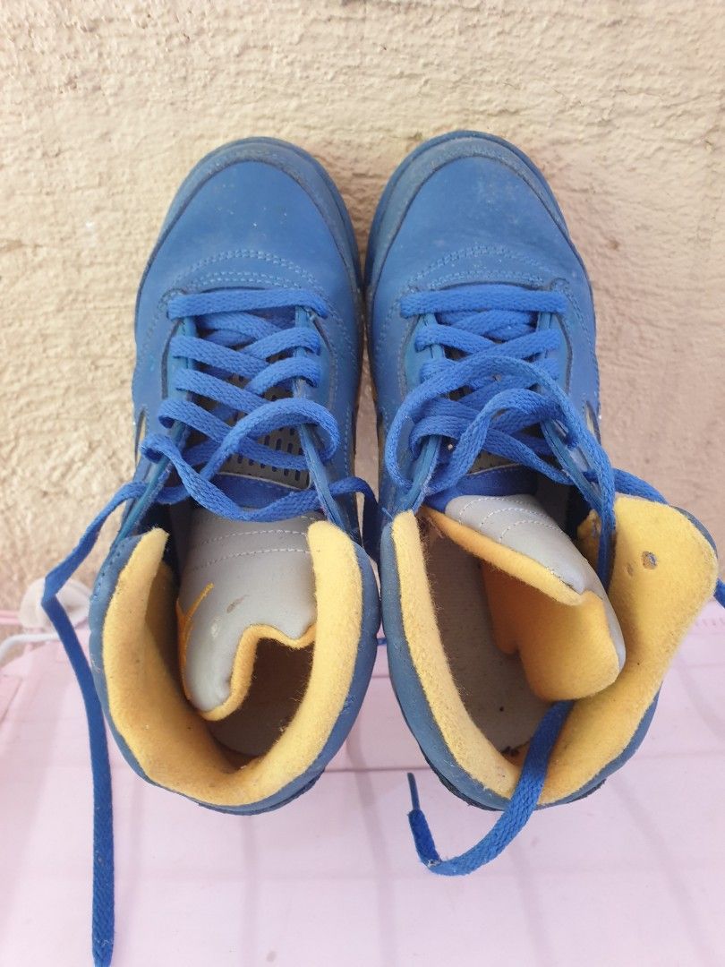 Jordan 5 Laney JSP (PS) (Category: Babies & Kids Fashion) located in Las Pinas. Submitted by anggesmart (Listing ID 1468382672, Image 3). Description: - Model: Air Jordan 5 Retro 'Laney' - Size: Kids / Preschool 1Y - Colorway: Blue nubuck upper with yellow and grey details - Features: Embroidered '23' on the heel and iconic speckled midsole - Condition: Normal wear on uppers and soles - Packaging: Includes original box with retail stickers attach