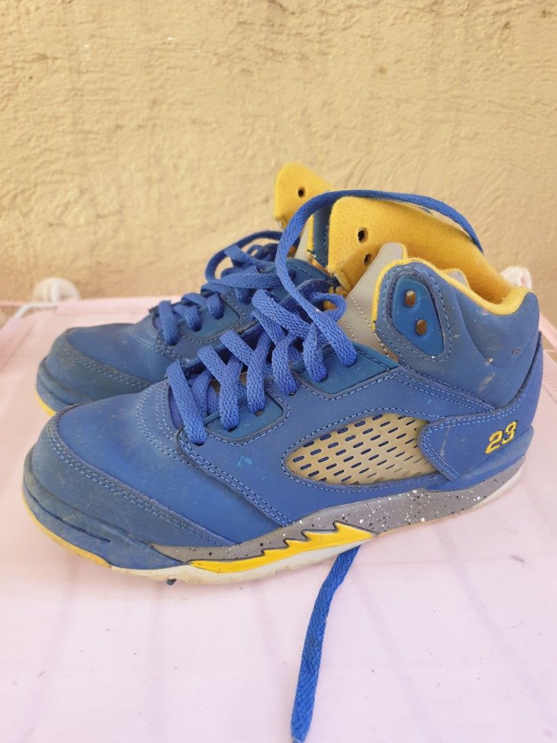 Jordan 5 Laney JSP (PS) (Category: Babies & Kids Fashion) located in Las Pinas. Submitted by anggesmart (Listing ID 1468382672, Image 2). Description: - Model: Air Jordan 5 Retro 'Laney' - Size: Kids / Preschool 1Y - Colorway: Blue nubuck upper with yellow and grey details - Features: Embroidered '23' on the heel and iconic speckled midsole - Condition: Normal wear on uppers and soles - Packaging: Includes original box with retail stickers attach