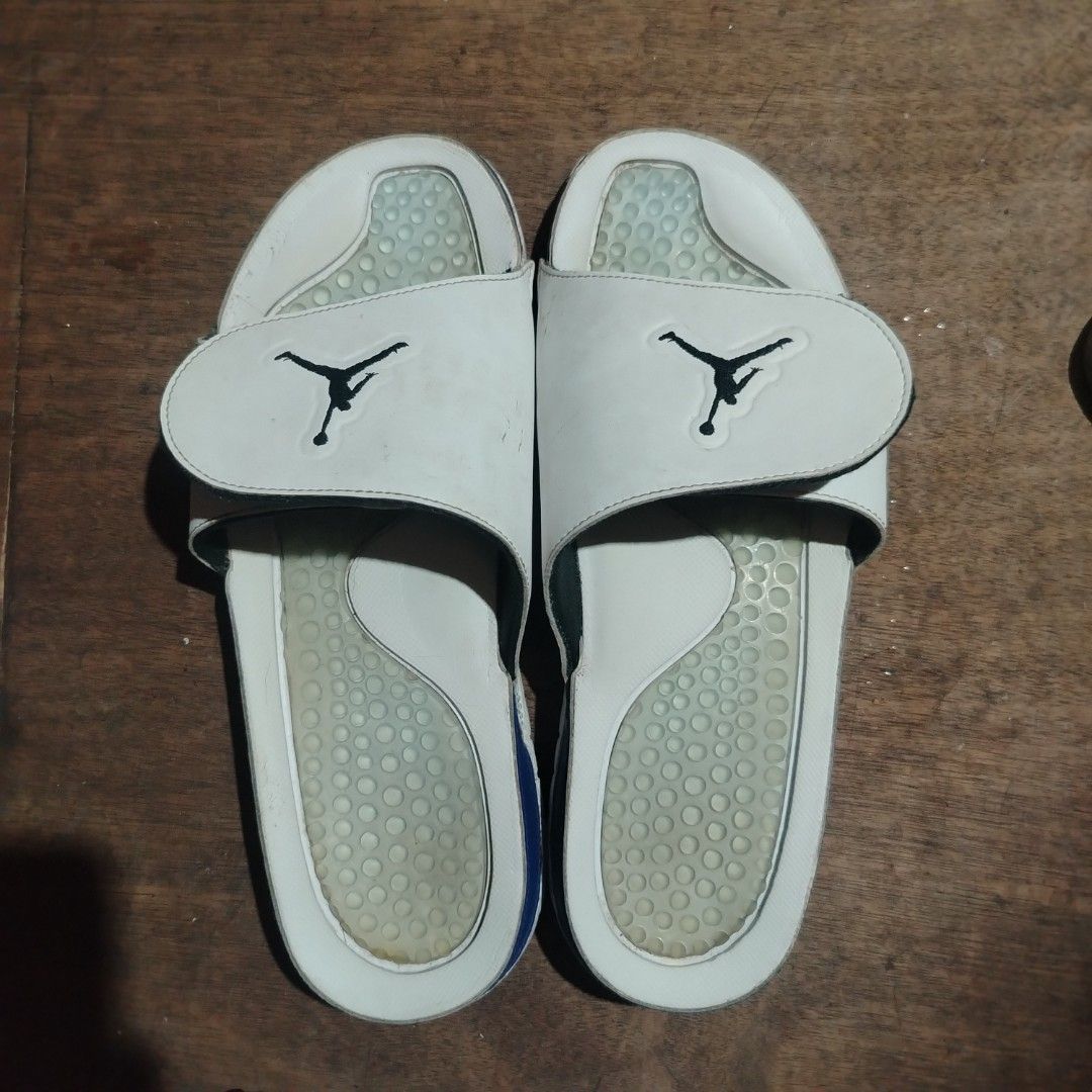 Jordan Hydro Slides White Black Blue (Category: Slippers & Slides) located in Manila. Submitted by boriz_goodman (Listing ID 1468463003, Image 2). Description: - Brand: Jordan - Color: White and blue with classic Jumpman logo - Features: Adjustable strap and textured footbed for grip and comfort - Condition: Shows normal wear with dirt on the tread and minor side glue separation near the blue accent - Status: Still very wearable for casual, every