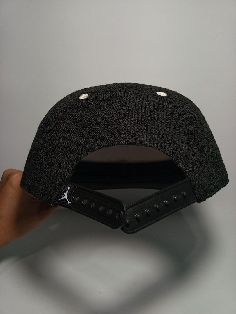 Jordan Jumpman Black Snapback Cap (Category: Caps & Hats) located in Lucena. Submitted by sanera_23 (Listing ID 1468336472, Image 3). Description: - Brand: Jordan - Style: Classic black snapback cap - Details: White embroidered Jumpman logo and eyelets, contrast interior taping - Fit: Adjustable plastic snap closure (Youth size) - Condition: Clean inside and out.
