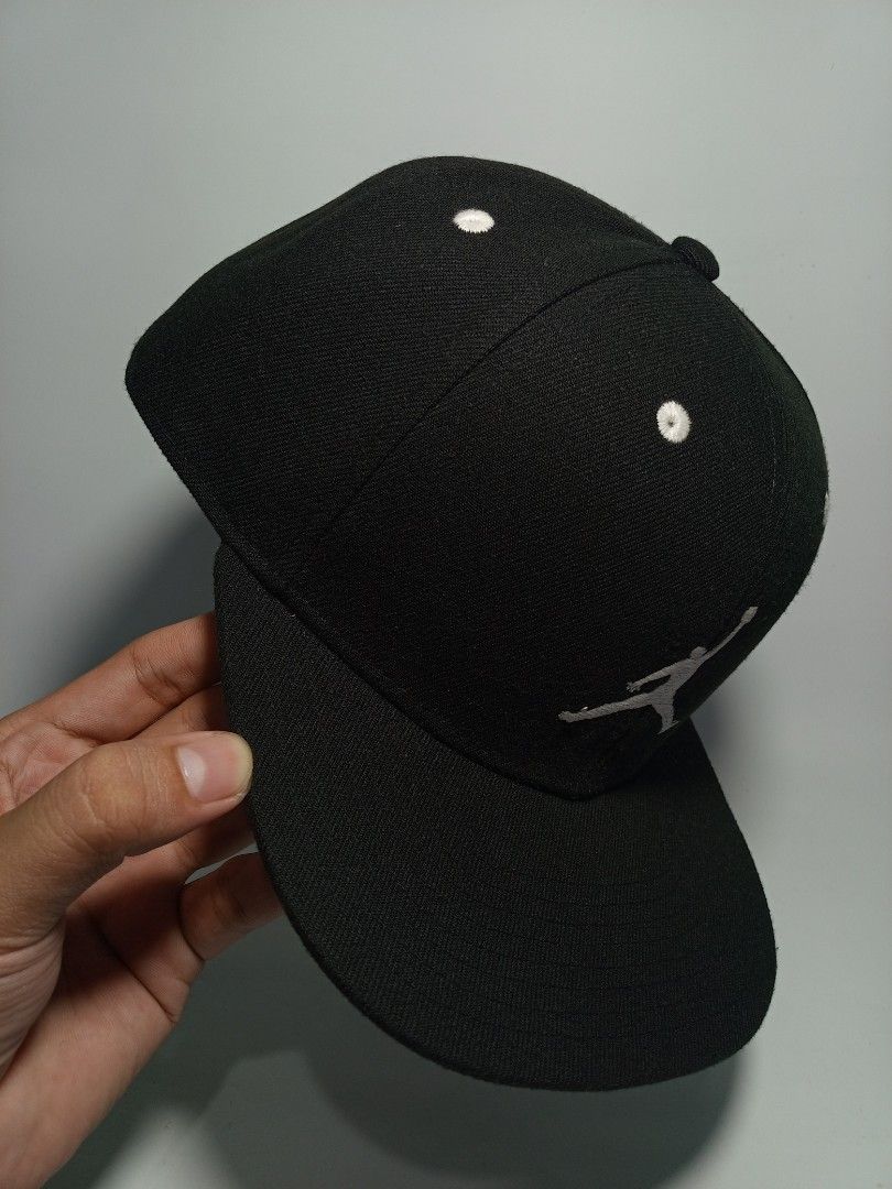 Jordan Jumpman Black Snapback Cap (Category: Caps & Hats) located in Lucena. Submitted by sanera_23 (Listing ID 1468336472, Image 2). Description: - Brand: Jordan - Style: Classic black snapback cap - Details: White embroidered Jumpman logo and eyelets, contrast interior taping - Fit: Adjustable plastic snap closure (Youth size) - Condition: Clean inside and out.