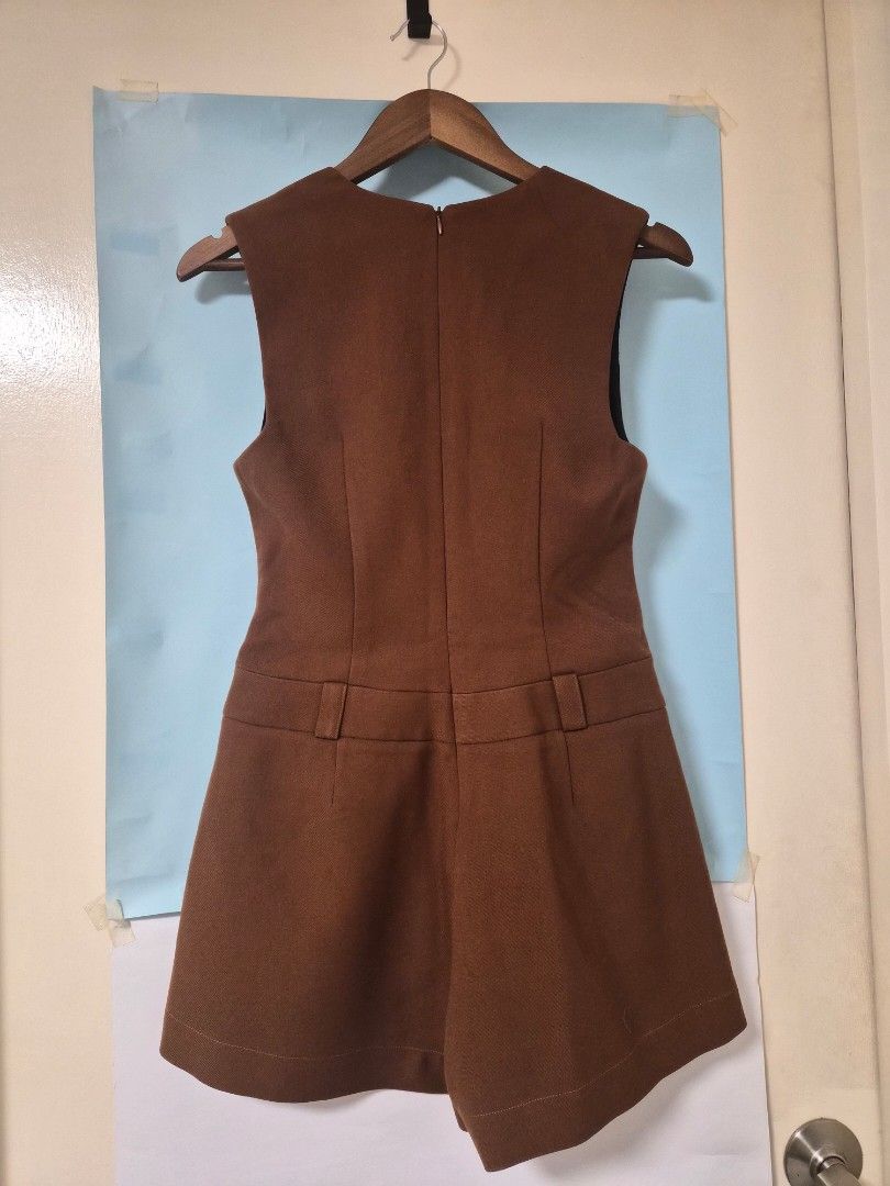 Joven Brown Sleeveless Button Front Romper Size M (Category: Rompers) located in Manila. Submitted by prelovedbyc.hannah (Listing ID 1468356221, Image 2). Description: - Brand: Joven - Size: Medium - Color: Brown - Style: Sleeveless romper with deep v-neckline and front button closure - Details: Decorative front flap pockets, built-in belt loops, and back zipper - Lining: Fully lined in black - Fabric: Structured with a nice weight - Condition: C