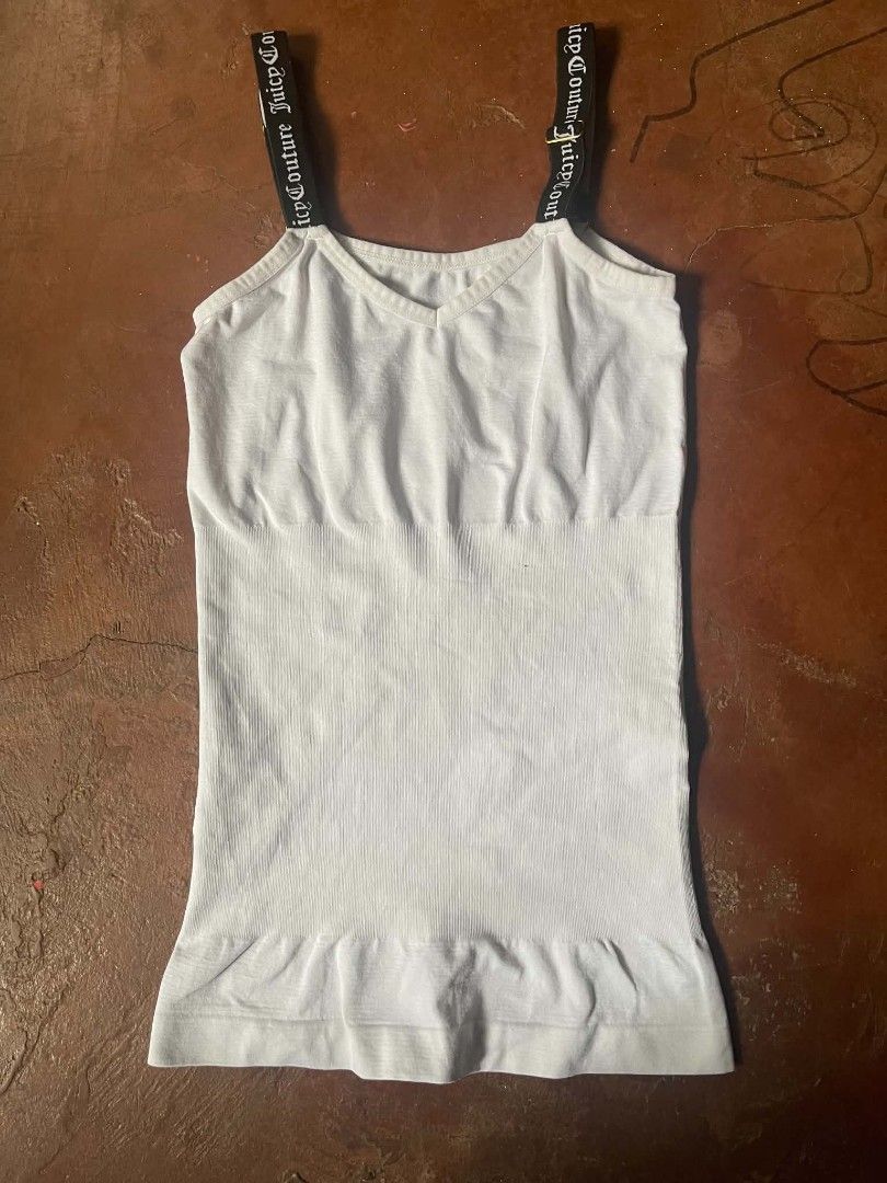 Juicy Couture White Cami Tank Top Size M (Category: Sleeveless) located in Gumaca. Submitted by makuliti (Listing ID 1468307628, Image 2). Description: - Brand: Juicy Couture - Size: M - Color: White with black straps - Material: 90% nylon, 10% spandex (super stretchy) - Design: Ribbed texture, V-neckline, seamless fitted body - Details: Black elastic straps featuring white Gothic script logo branding and gold stamped logo inside neckline - Condi