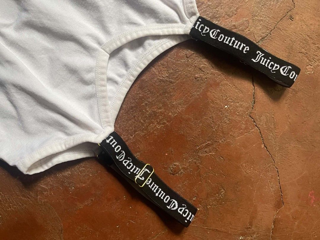 Juicy Couture White Cami Tank Top Size M (Category: Sleeveless) located in Gumaca. Submitted by makuliti (Listing ID 1468307628, Image 1). Description: - Brand: Juicy Couture - Size: M - Color: White with black straps - Material: 90% nylon, 10% spandex (super stretchy) - Design: Ribbed texture, V-neckline, seamless fitted body - Details: Black elastic straps featuring white Gothic script logo branding and gold stamped logo inside neckline - Condi