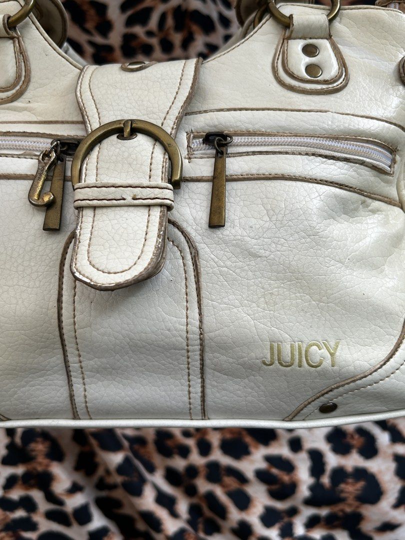 Juicy Couture white shoulder bag with gold hardware (Category: Shoulder Bags) located in Los Banos. Submitted by samsukehiro (Listing ID 1468381601, Image 3). Description: - Brand: Juicy Couture (ntguarntd) - Color: White faux leather with metallic gold logo lettering - Hardware: Antique brass tone with signature 'J' zipper pull - Handles: Dual top handles for easy shoulder wear - Pockets: Front zip pockets, exterior back zip pocket, and multiple