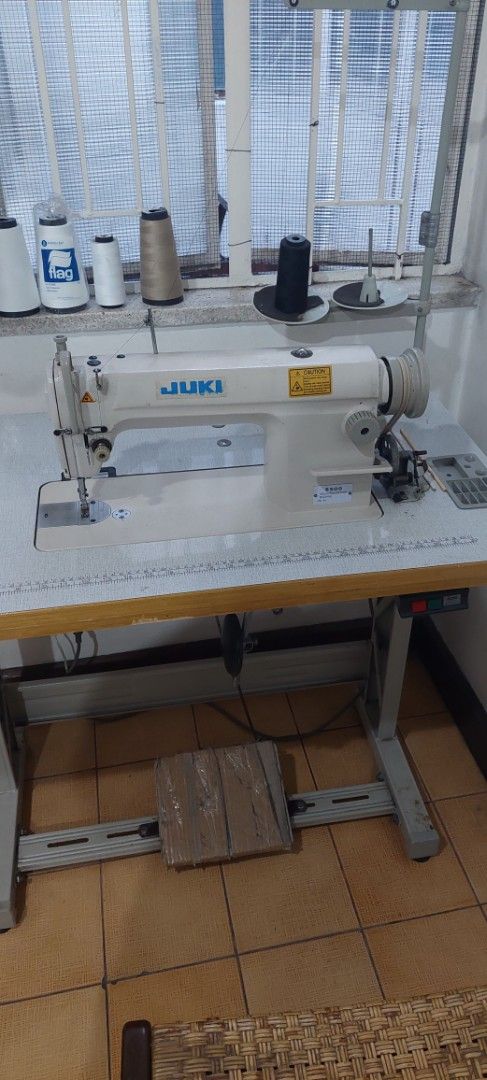 Juki Industrial Sewing Machine with Table (Category: Industrial Equipment) located in Manila. Submitted by mcangwong80885 (Listing ID 1468362816, Image 2). Description: - Authentic Juki industrial sewing machine - Built-in metal table stand - foot pedal underneath - Includes a multi-spool thread stand - Ideal for heavy-duty sewing, thick fabrics, and professional tailoring.