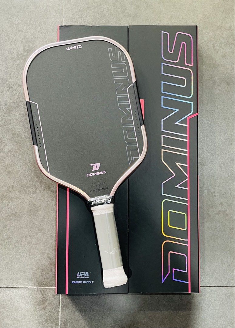 Kamito Dominus Pickleball Paddle with Box (Category: Racket and Ball Sports) located in Manila. Submitted by cairosebastian (Listing ID 1468303704, Image 2). Description: - Brand: Kamito Dominus Pickleball Paddle (UPA Pro Certified) - Condition: Brand new, grip still wrapped in plastic - Face: Black carbon fiber with a colorful edge guard and striking branding - Performance: Excellent control paddle, ideal for players looking to level up their ga