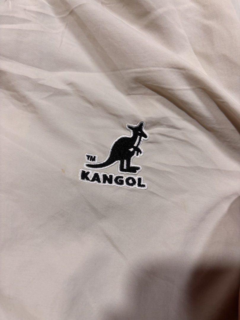 Kangol Beige Hooded Windbreaker Jacket (Category: Coats, Jackets and Outerwear) located in Mabalacat. Submitted by _limitlessfashion (Listing ID 1468300525, Image 3). Description: - Brand: Kangol Crop Windbreaker - Color: Beige - Size medium on tag - Length 21 - Width 24 - Crop vibe - No major issue, need wash only - Style: Lightweight cropped windbreaker - Features: Full zip front, adjustable drawstring hood, and elastic hem and cuffs - Pockets: