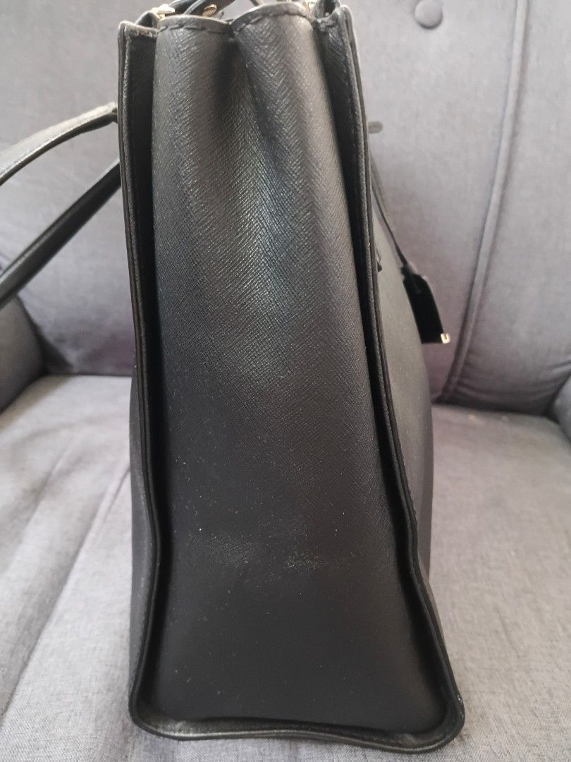 Kate Spade Black Tote Bag (Category: Tote Bags) located in Binangonan. Submitted by chingtp (Listing ID 1468288880, Image 2). Description: - Authentic Kate Spade black tote bag - Durable Saffiano leather with gold-tone hardware - Secure zip-top closure and double top handles - Protective metal feet on the bottom - Spacious black and white striped fabric interior with pockets - Perfect for work, school, or everyday essentials.