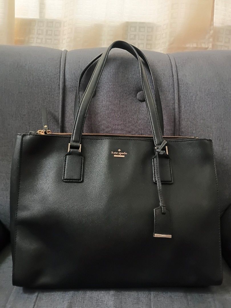 Kate Spade Black Tote Bag (Category: Tote Bags) located in Binangonan. Submitted by chingtp (Listing ID 1468288880, Image 1). Description: - Authentic Kate Spade black tote bag - Durable Saffiano leather with gold-tone hardware - Secure zip-top closure and double top handles - Protective metal feet on the bottom - Spacious black and white striped fabric interior with pockets - Perfect for work, school, or everyday essentials.